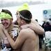 EMU student Daniel Harrington from the Dirty Dan and the Ice Cold Clan huddle together for warmth before jumping in Ford Lake on Saturday, Feb. 16. Daniel Brenner I AnnArbor.com